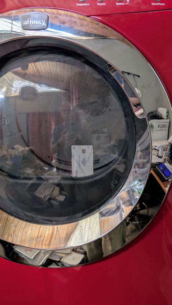 Credit card stuck to the inside of the dryer window