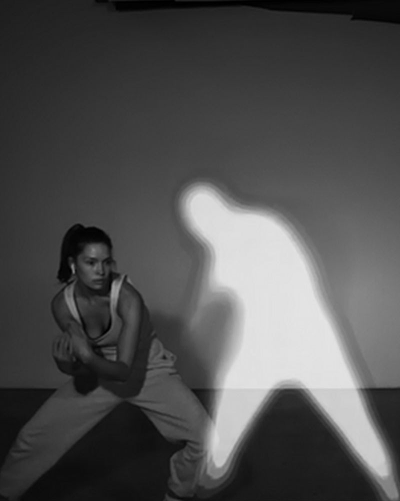 A female dancer performing with an avatar