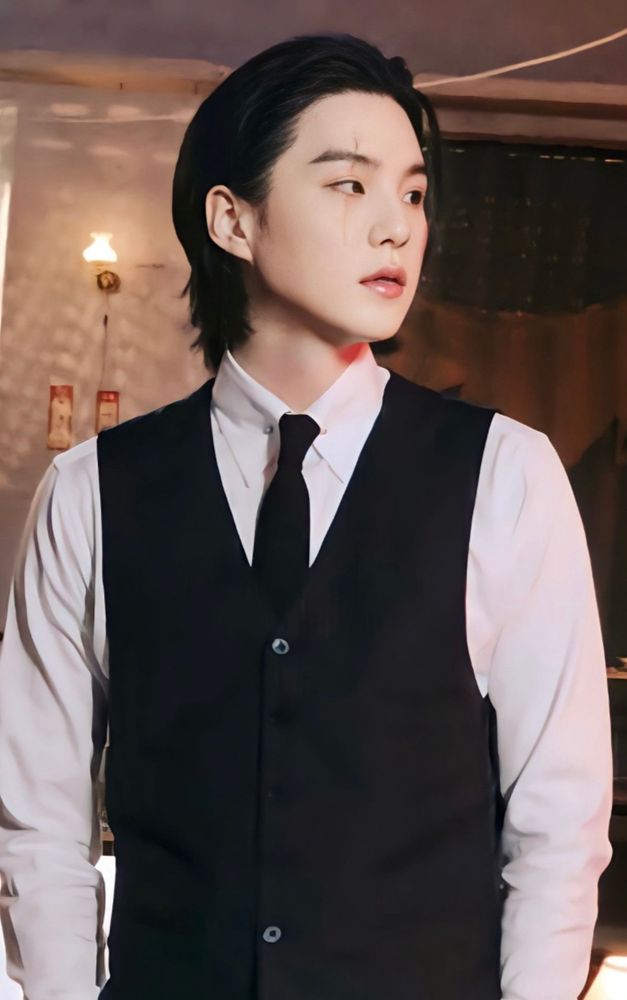 Yoongi in a suit with a black tie but no suit jacket