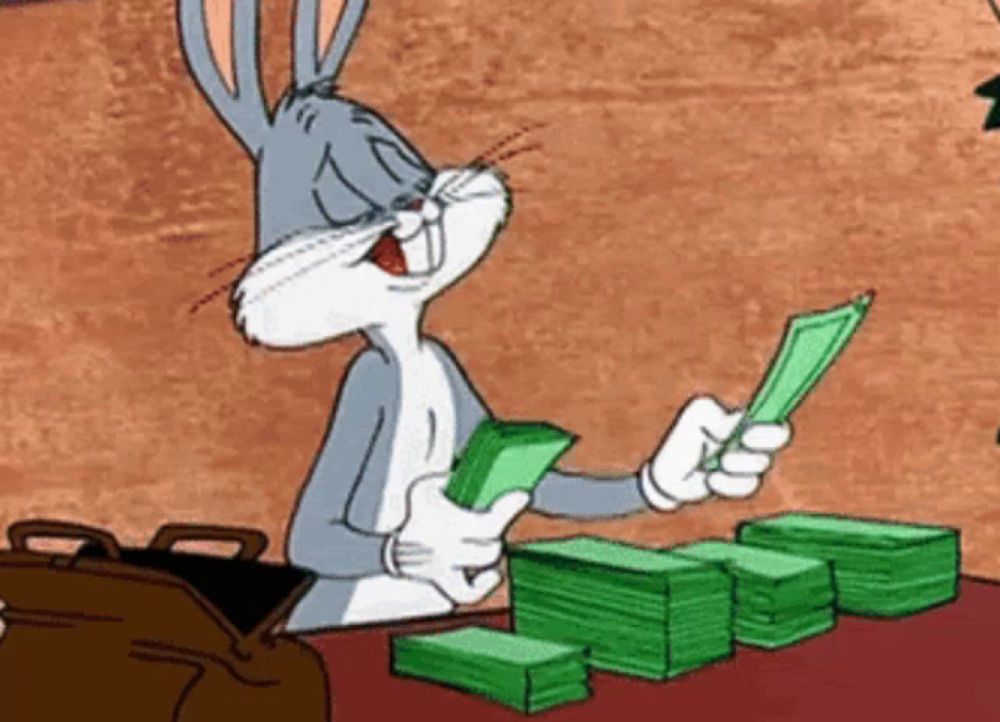 bugs bunny is holding a stack of money in his hands