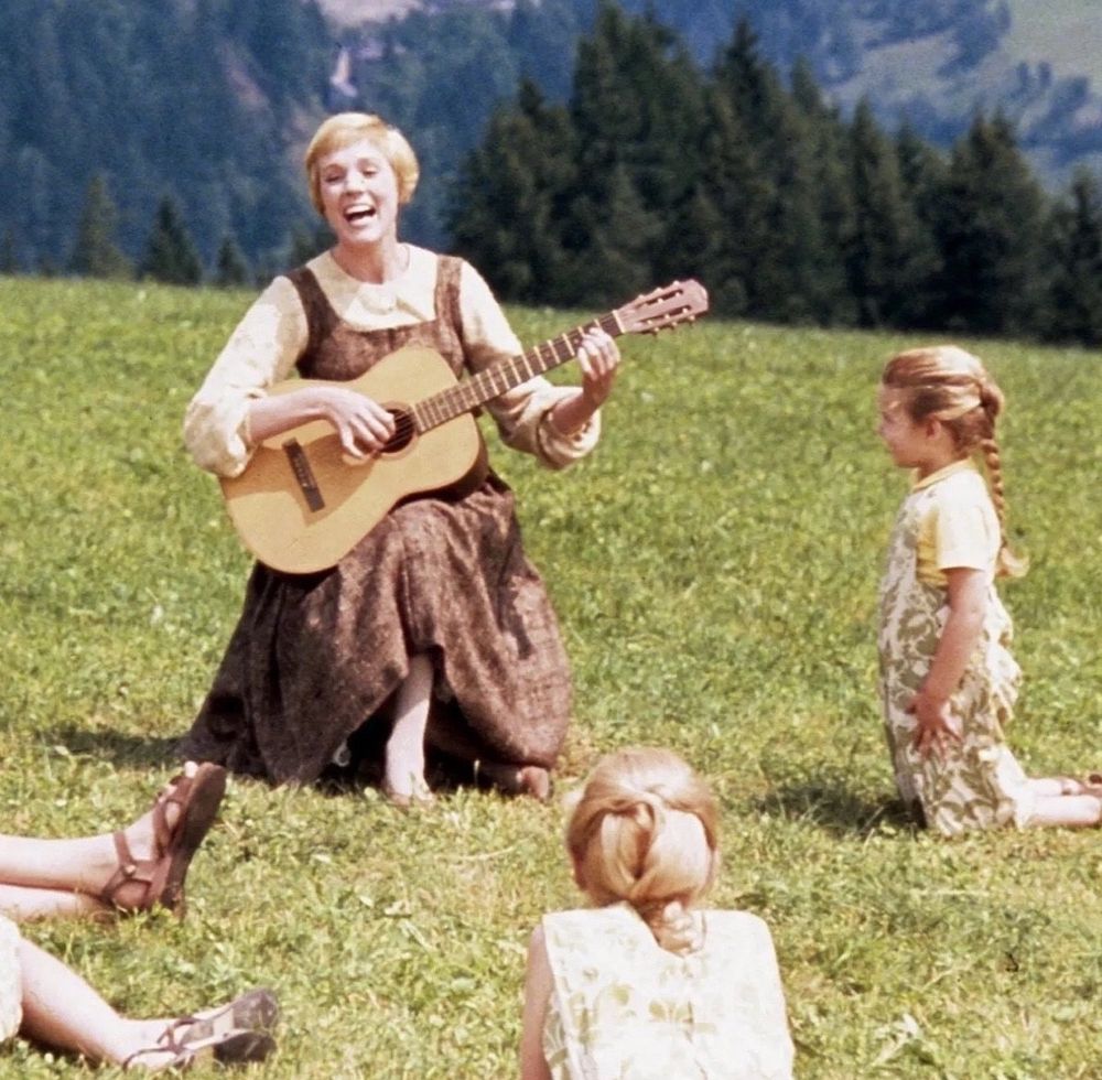 The scene from the Sound of Music where Julie Andrews plays guitar and sings with the kids in the mountains.