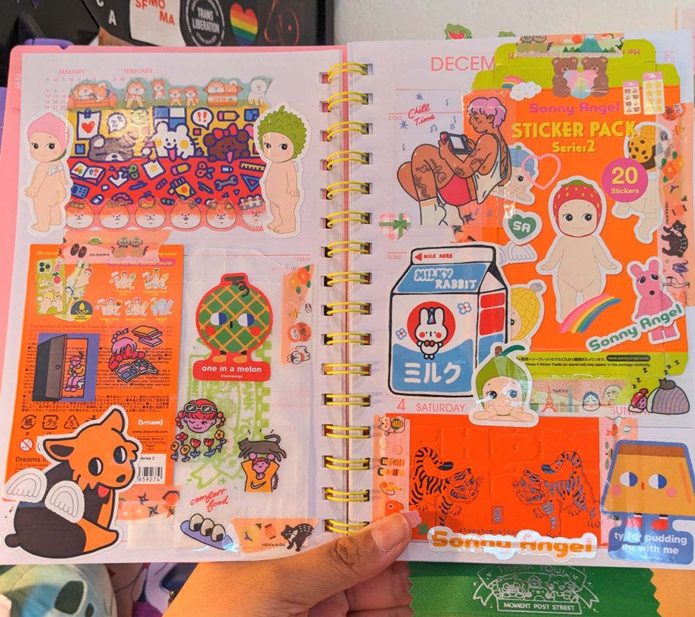 scrapbook spread that includes sonny angel sticker pack series 2 packaging and stickers, stickers from various small businesses, and a tattoo business card