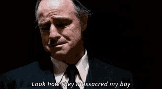 Marlon Brando as Vito Corleone looks downwards at the (unseen) body of his son, Sonny, and says ‘Look how they massacred my boy’.