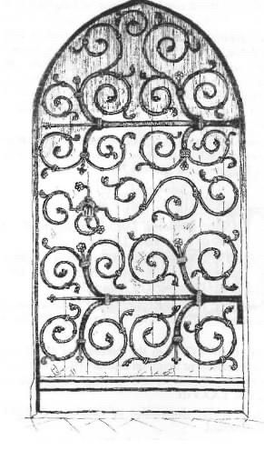 A wooden church door with intricate swirly design pattern made from iron. 