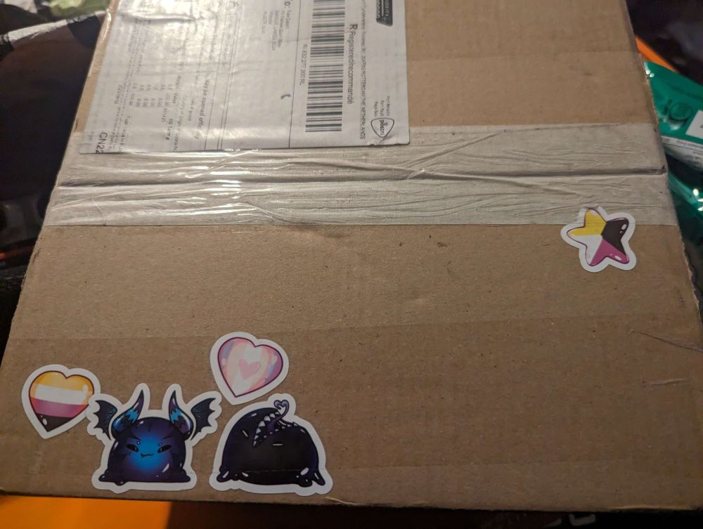 A shipping box covered in slime stickers