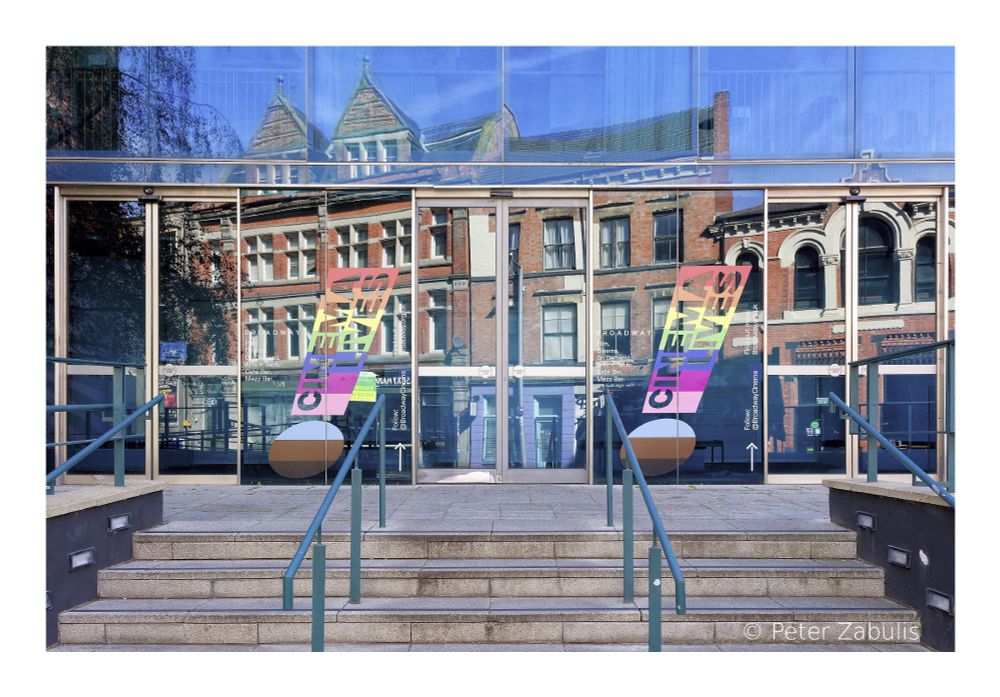 Reflections of buildings on the glass frontage of the Broadway Cinema in Nottingham.