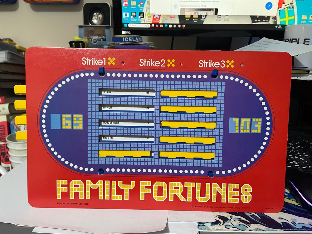 Family Fortunes sliding slats board with a pre-printed surround. One of the teams apparently has 69 points. Nice.