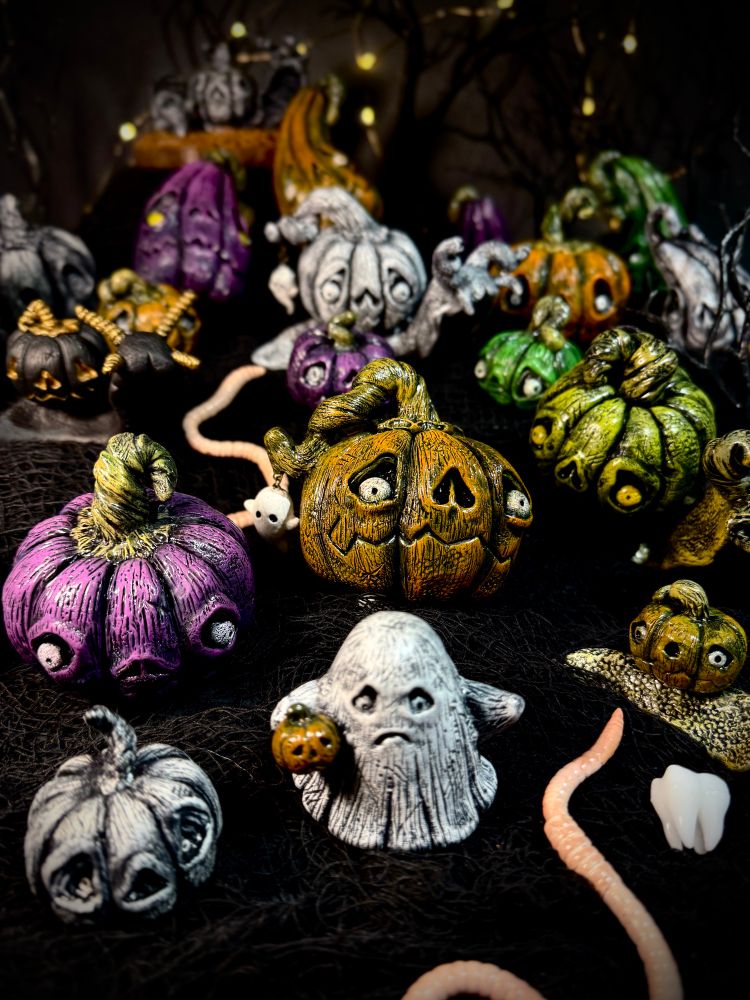 Spooky inspired polymer clay pieces. Pumpkins with silly/creepy faces, snails with pumpkins for shells.