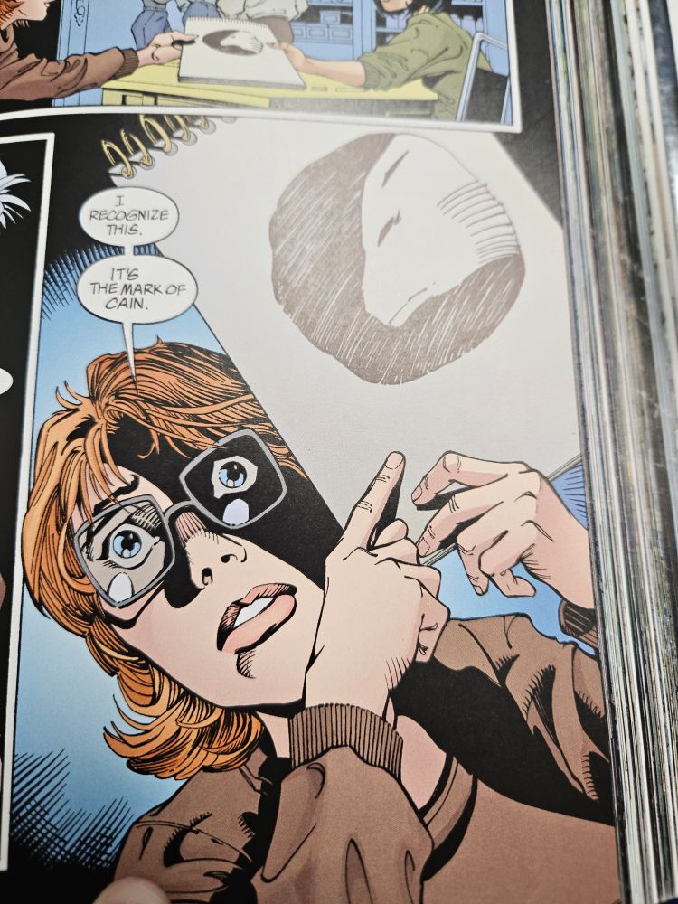 Barbara Gordon, looking alarmed, holding a sketchpad. she is saying 