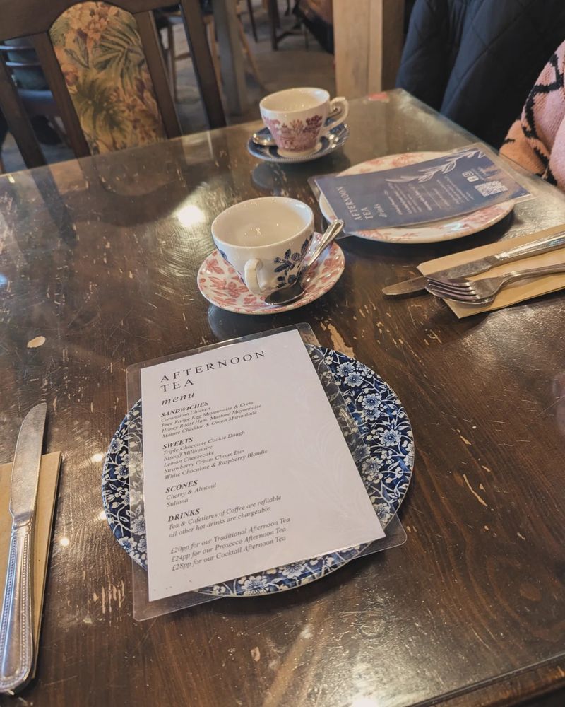 Afternoon tea menu listing the sandwiches, the sweets and the scones