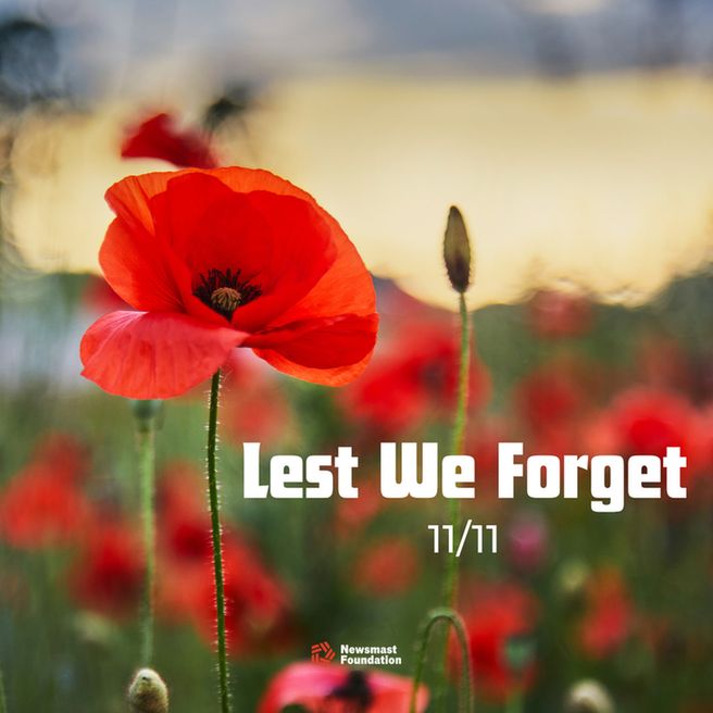 An image of a poppy amongst a field of poppies. Alongside it is the text: Lest we Forget. 11/11.