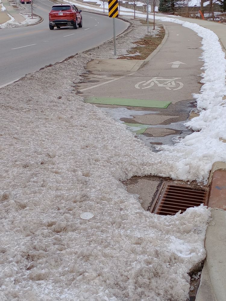 Third Street Bike Lane obstructed by dirty snow and ice for weeks. Bloomington Indiana 