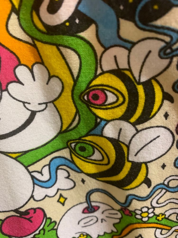 Strange fabric design. A cartoon bee has a big green eyeball.
