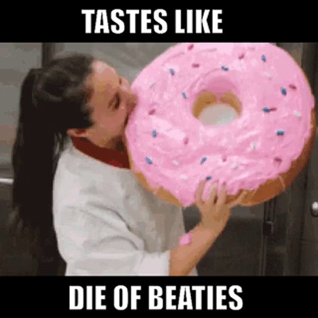 a woman is kissing a giant pink donut with the words tastes like die of beaties below it