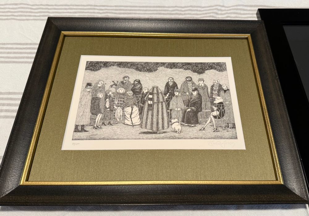 A print of an Edward Gorey line drawing of a group of people in 1920s-ish clothing gathered in two rows (one seated, one standing) under a lowering sky. In the foreground, a man faces the group with his back to the viewer, wearing an enormous fur coat with a striped scarf over one shoulder. A small dog is beside him. 