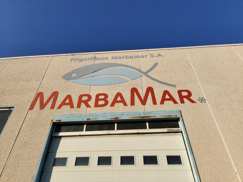 A large fish symbol over the door to a large fish warehouse 