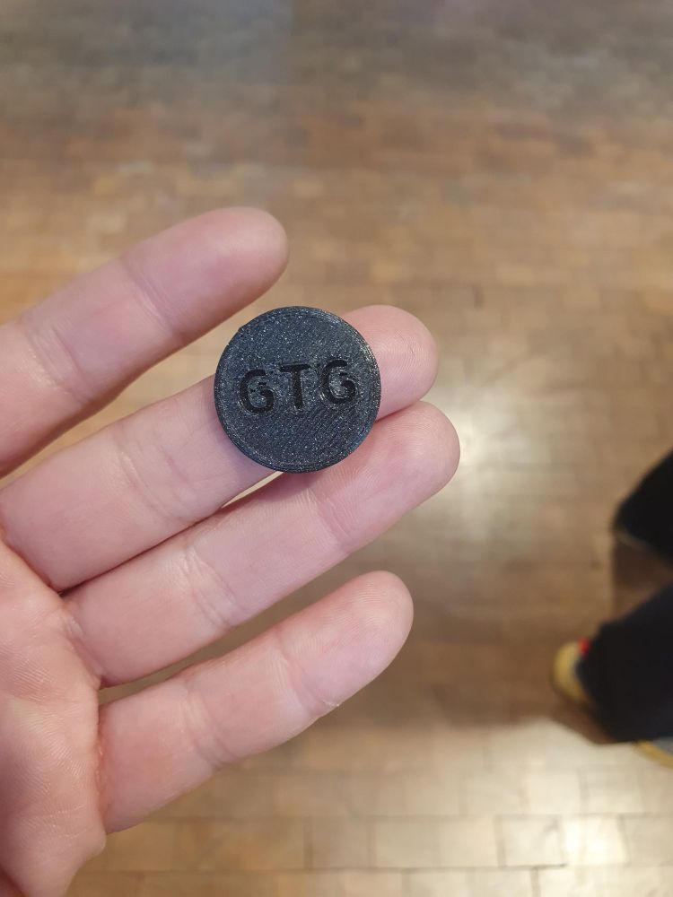 The finished GTG coin is shown. It is dark gray.