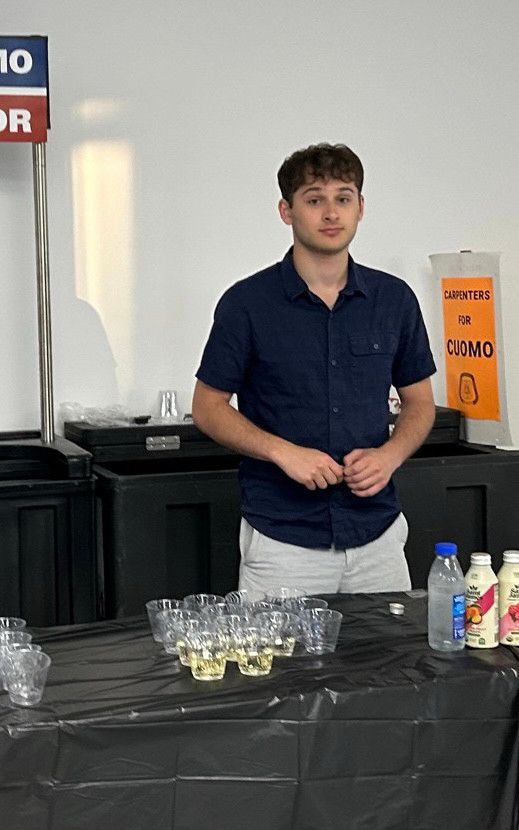 An incredibly sad display of a staffer behind the drinks table at the Cuomo headquarters 