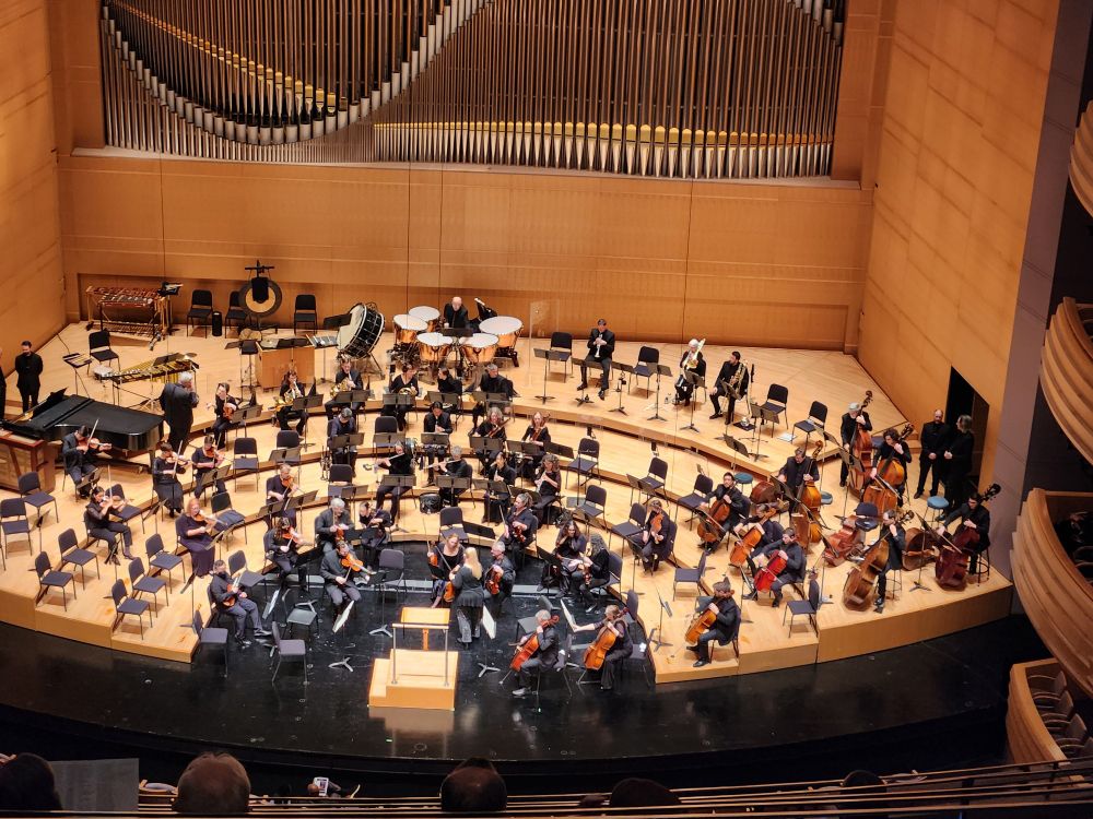Orchestra warming up before a concert, viewed from way, way, way above in the cheap seats