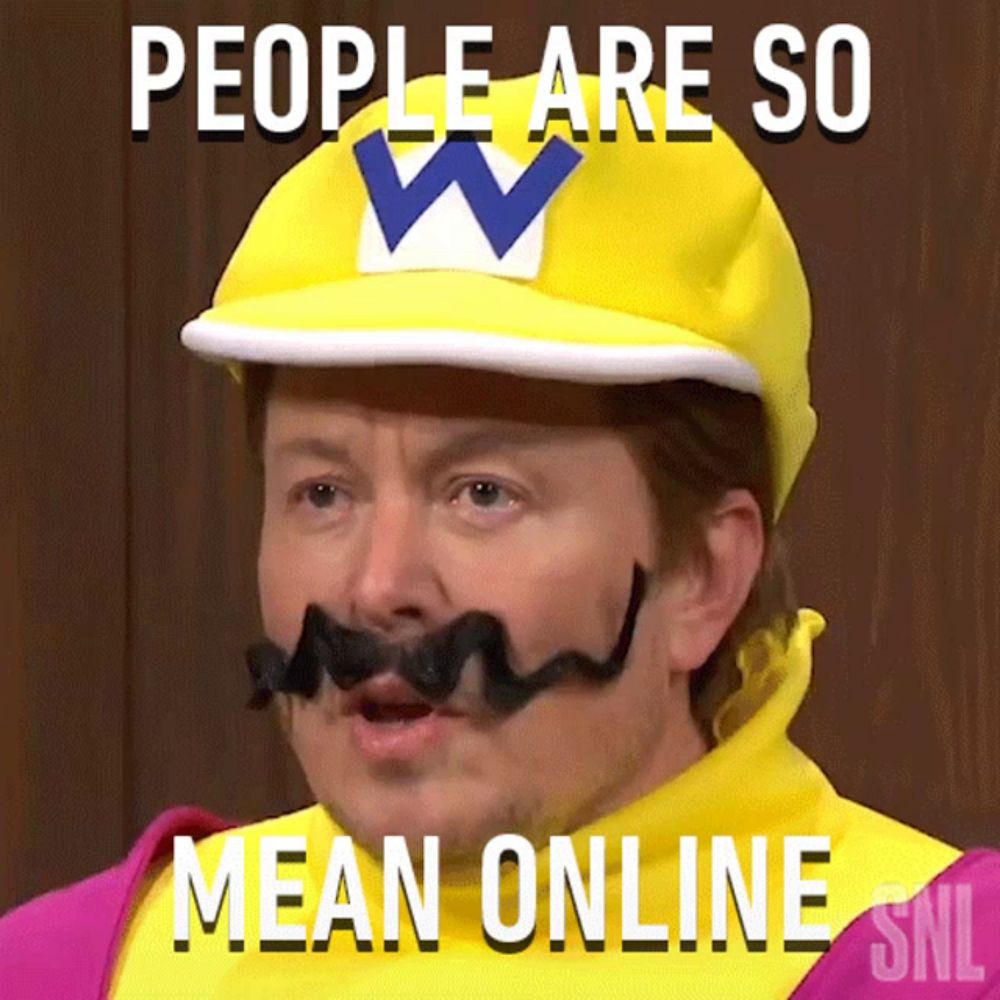 a man with a mustache wearing a wario hat says people are so mean online