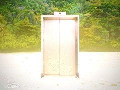 Gif mostrando um elevador na areia de uma praia. No fundo, uma mata verde.