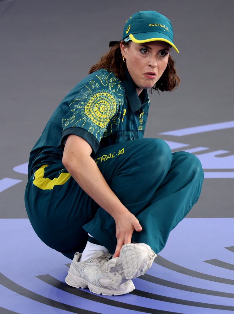 woman in a great outfit doing a breakdancing move (in her mind) during the 2024 olympics 