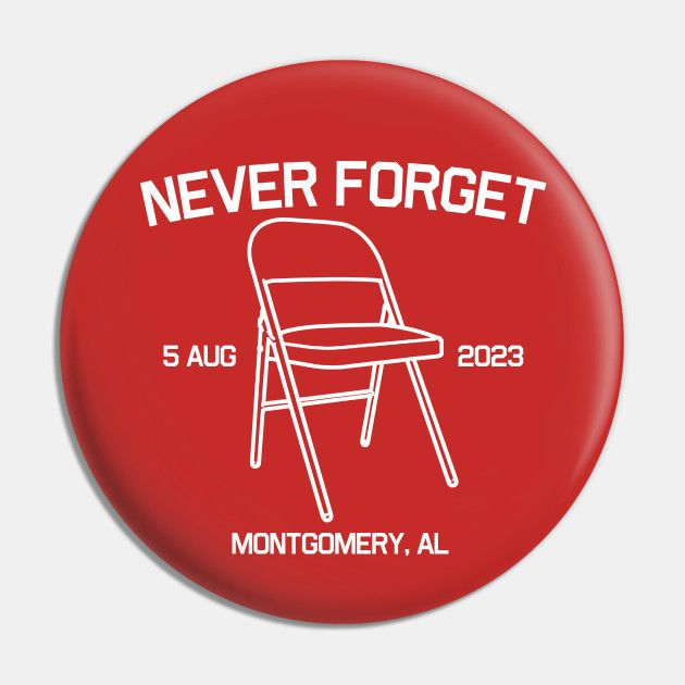 a red button inscribed with “never forget 5 aug 2023, montgomery, al” and featuring a folding chair 