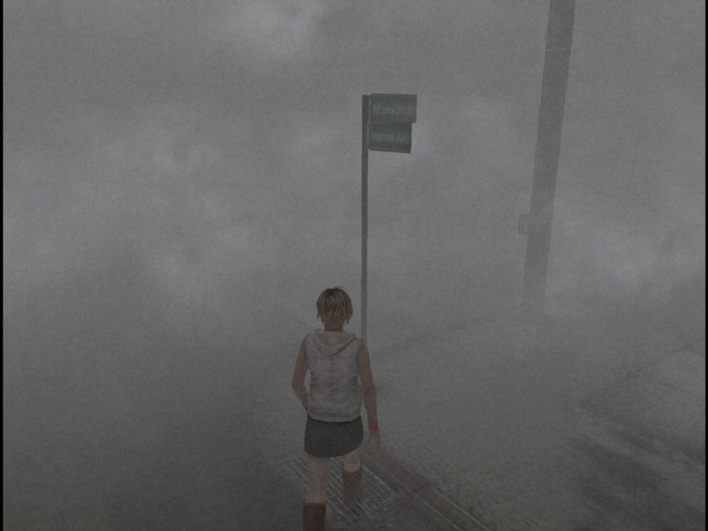 Screenshot from Silent Hill 3 showing Heather standing on a foggy street corner 