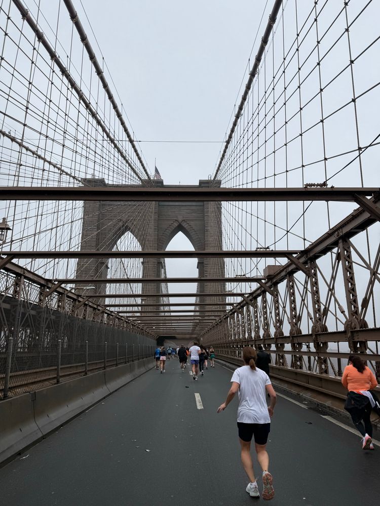 Image of the Brooklyn Bridge featuring several runners taken during the United NYC Half