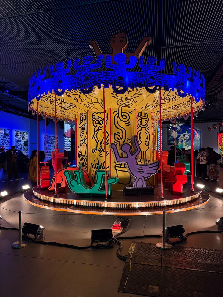 Carousel designed by Keith Haring, featuring abstract figures, on display at the Luna Luna exhibit 