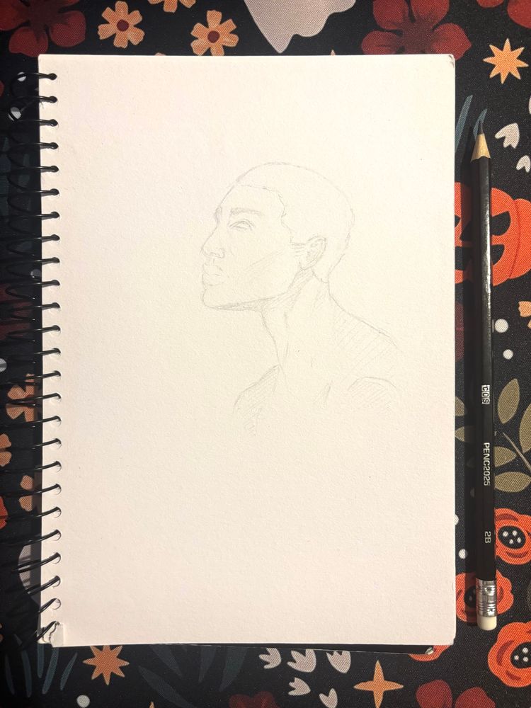 A pencil sketch from my sketchbook, drawn during a long commute - it shows a young man, looking upward, perhaps from his phone. His expression suggests that he is perhaps ready for this journey to be finished.