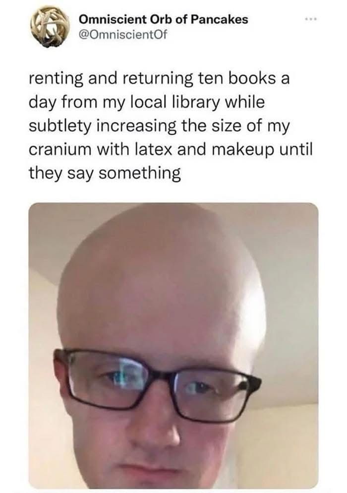 A photo of a person wearing a completely deadpan expression with a very large bald cap and glasses