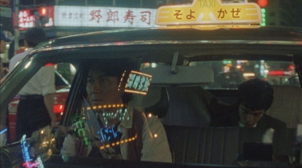 Kamikaze Taxi
Koji Yakusho drives a cab with a passenger in the back seat
