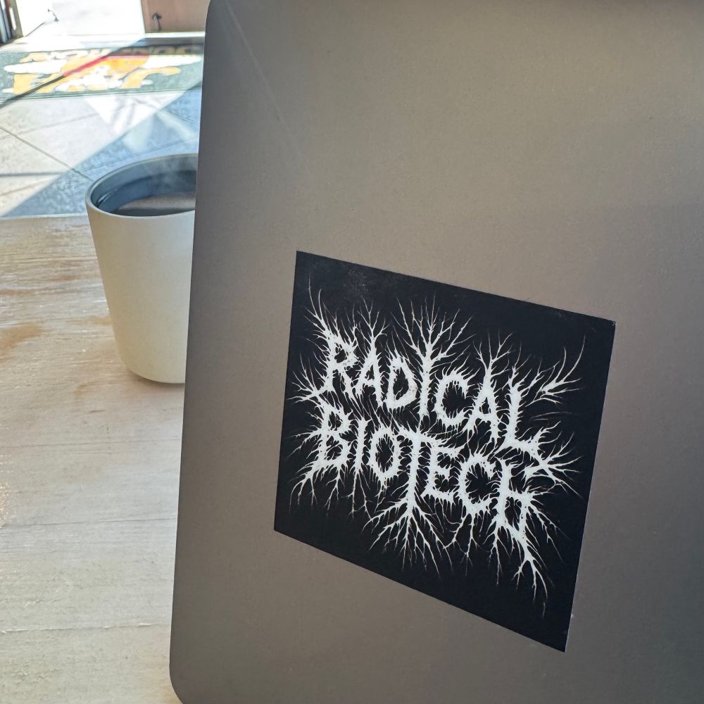 Photo of a "Radical Biotech" sticker on a laptop