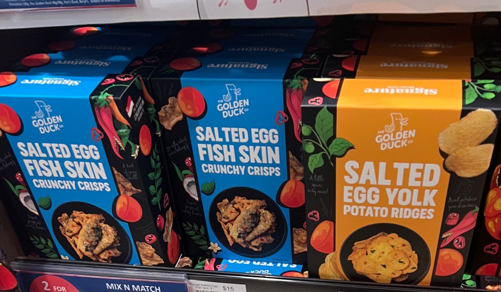 Boxes of crisps on a shelf: there’s salted egg fish skin and salted egg yolk flavour.