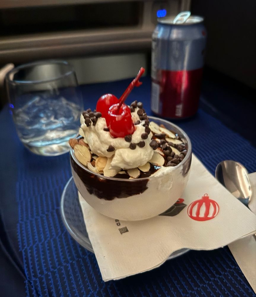 Ice cream sundae with cherry on top on an airplane