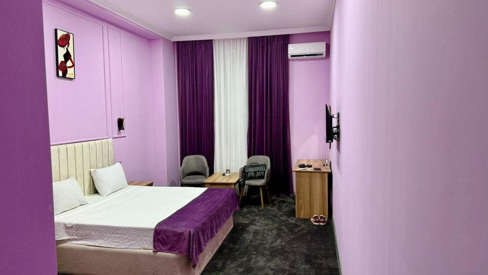 Brightly coloured but sparse hotel room.