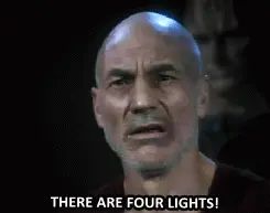 Gif of Sir Patrick Stewart as Cpt. Jean-Luc Picard, looking frustratred and screaming "There are four lights!"