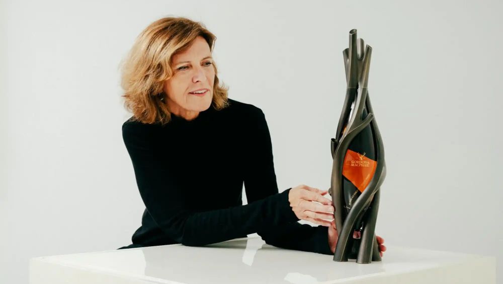 A promotional photo of Jeanne Gang admiring "Artistry in Oak", a £125K decanter for an 85-year old Glenlivet whisky.