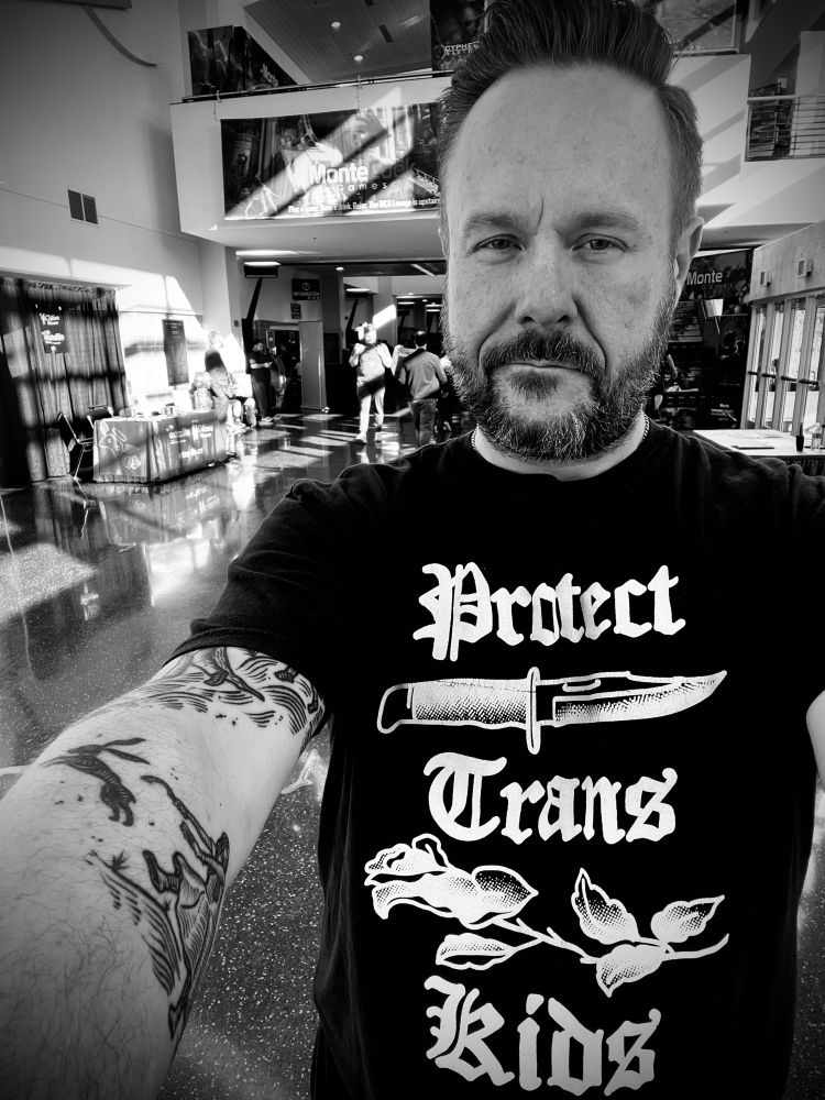 Selfie wearing “Protect Trans Kids” t-shirt at Gamehole Con 2025