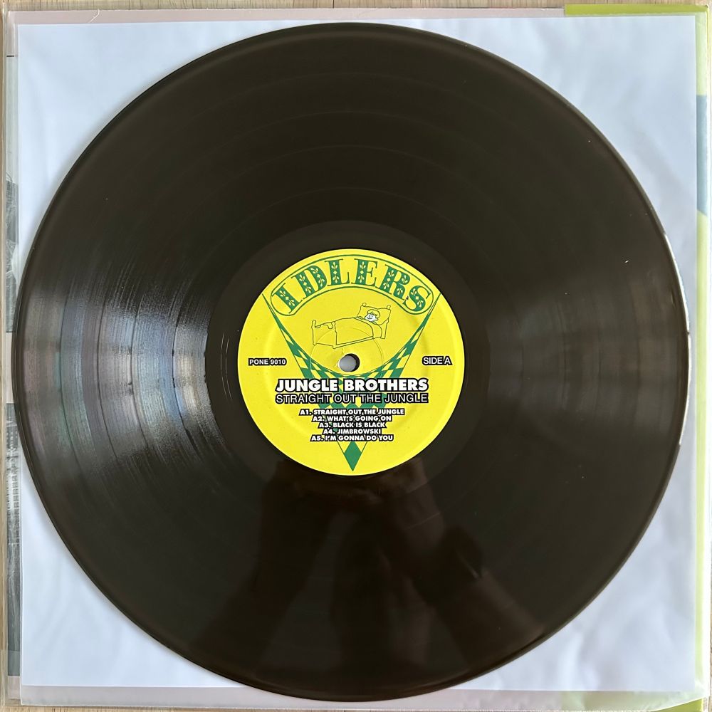 A photo of the smoky transparent vinyl variant of the Straight Out The Jungle album by the Jungle Brothers