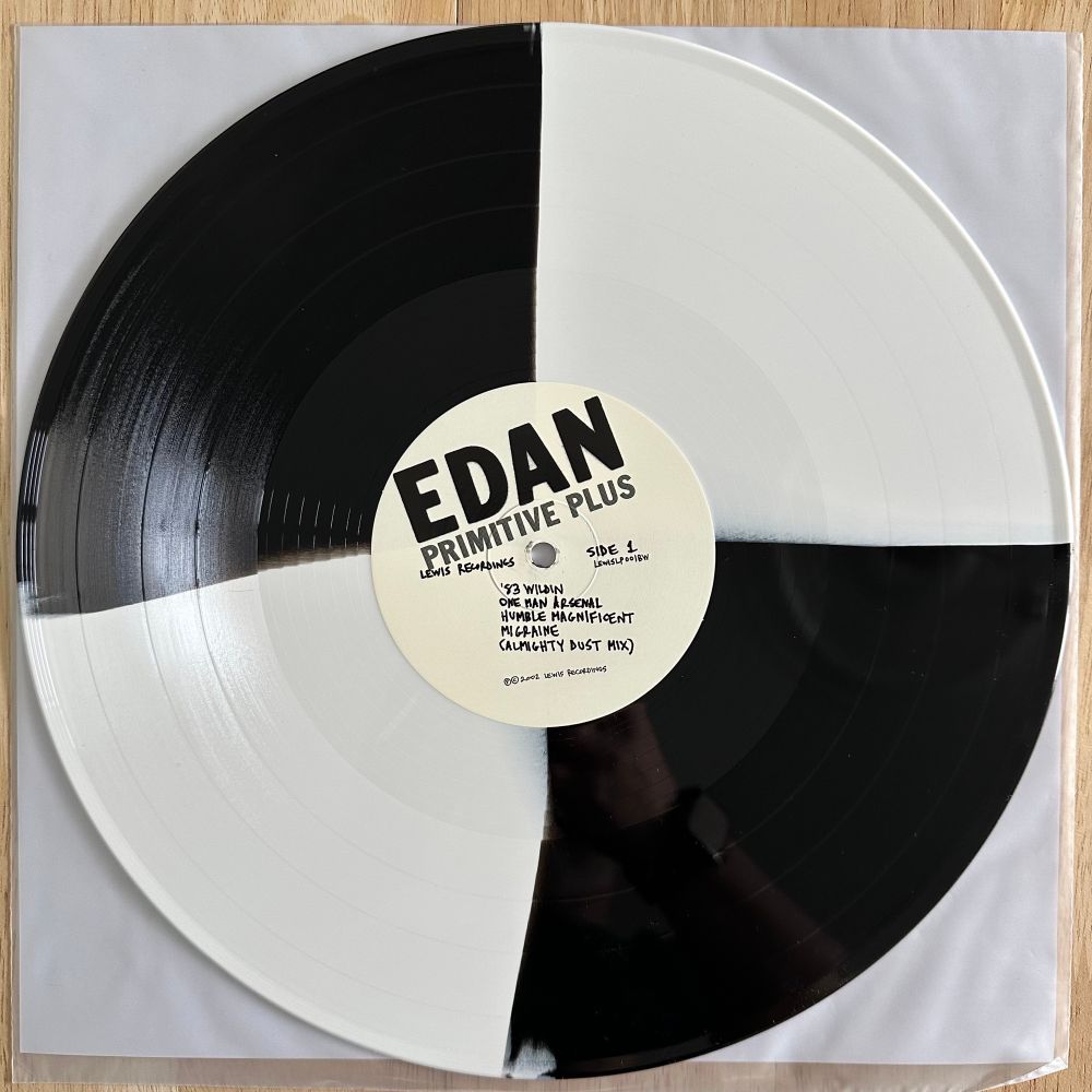 A photo of the black & white vinyl variant of Edan’s ‘Primitive Plus’ LP from 2002