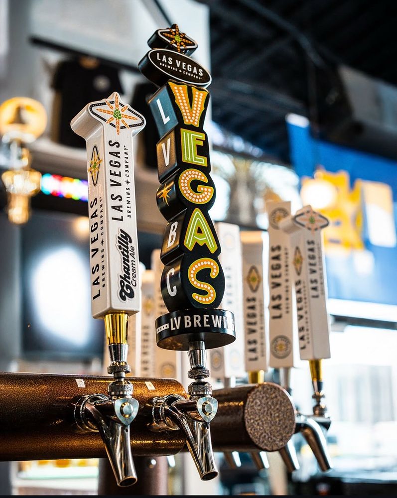 Black beer tap handle with the letters VEGAS in neon sign lettering style. 