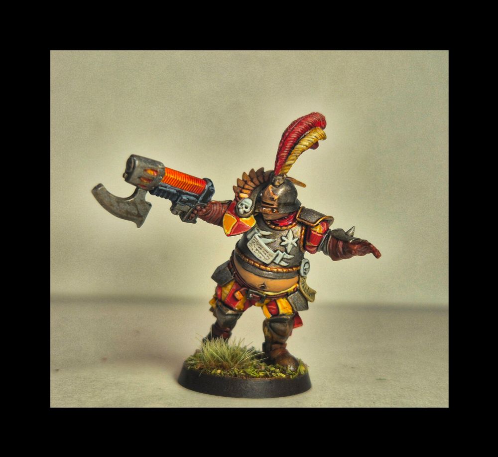 Picture of a Warhammer model. It is the base model of a blood bowl empire with a plasma rifle. Painted red and yellow 