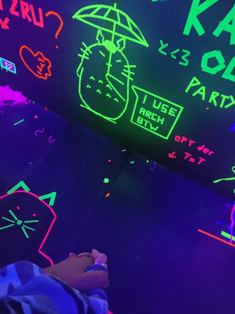 Holding hands with my wife infront of a wall with neoflourescent tape.