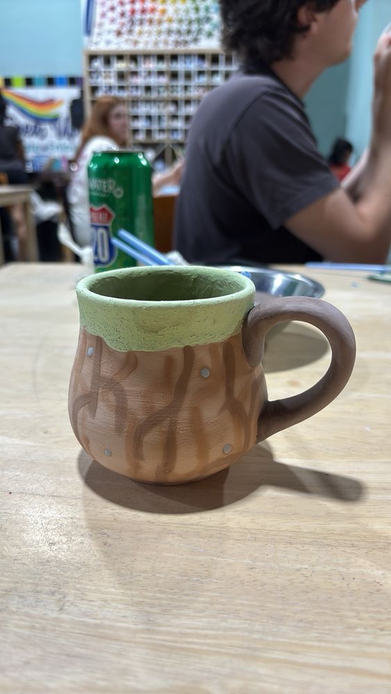 A painted mug in the style of grass and dirt