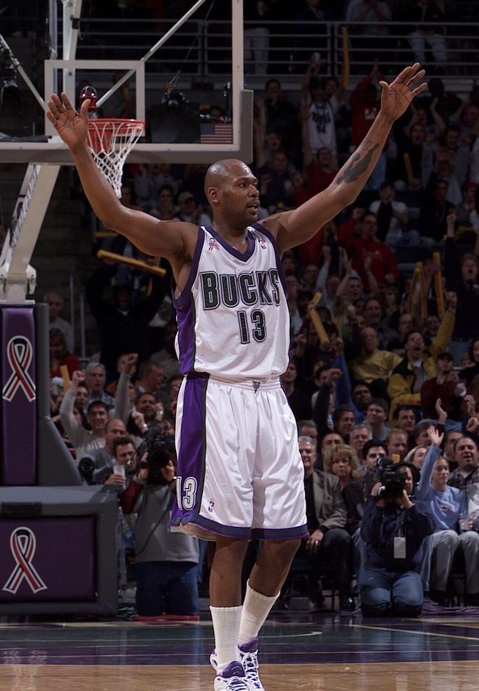 Glenn “Big Dog” Robinson wearing his white No. 13 Milwaukee Bucks uniform on court during a game from his career.