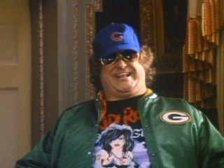 John Goodman in King Ralph. He is wearing a Packers jacket and a Cubs hat.