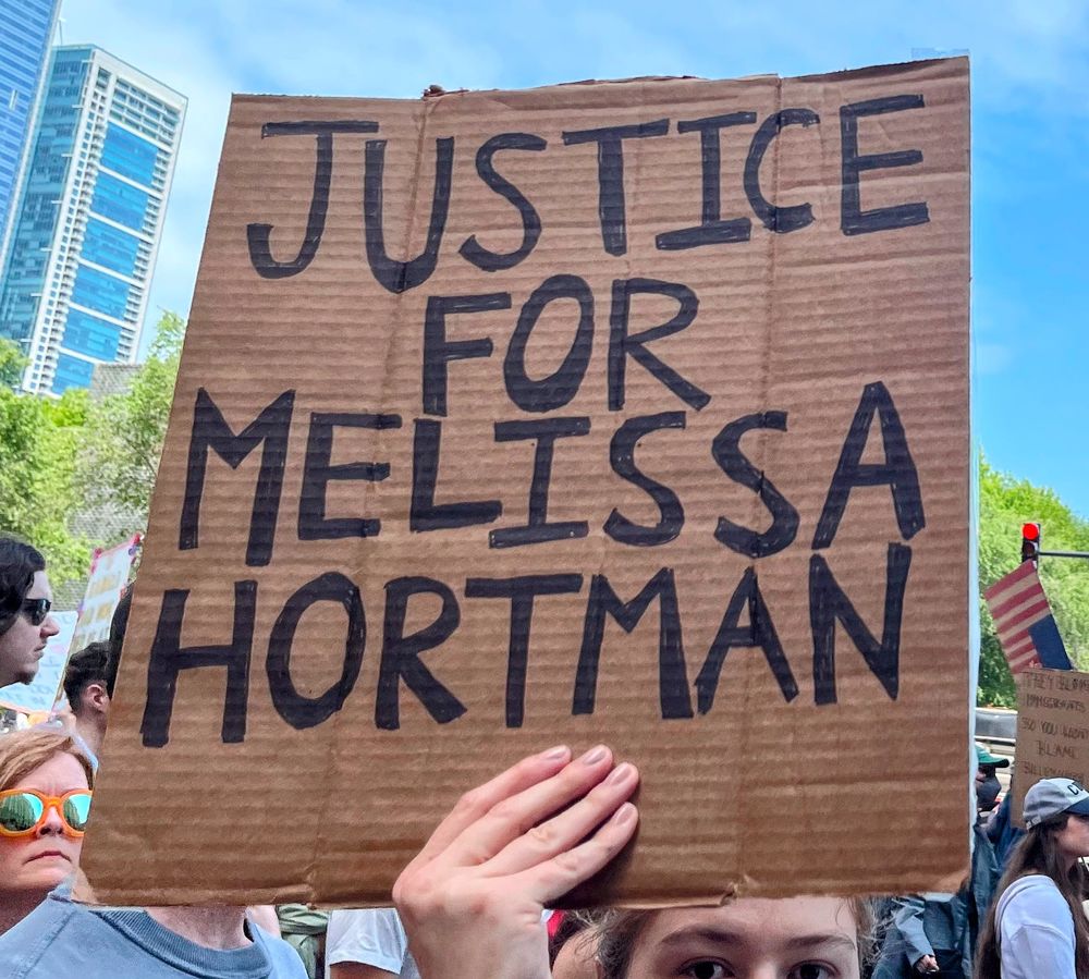 A protester holds a sign that reads: Justice for Melissa Horton.