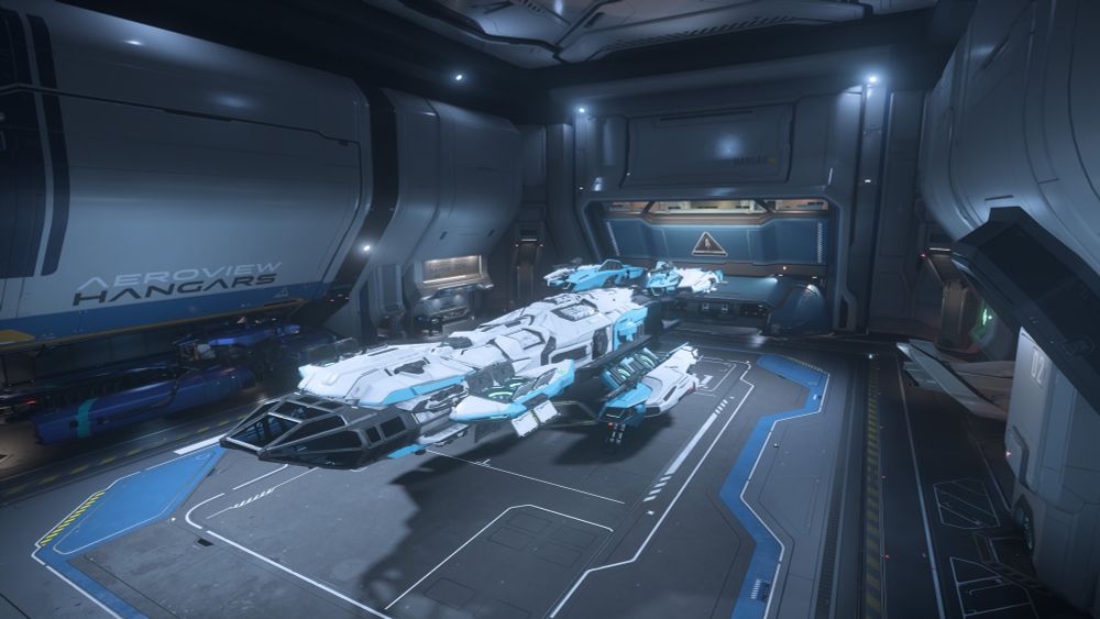 Purple BIS Vulture on the left of the hangar, Connie Taurus in the middle with the Microtech livery, and a pearl white 315p on the right